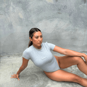 Grey short sleeve bodysuit modelling front on
