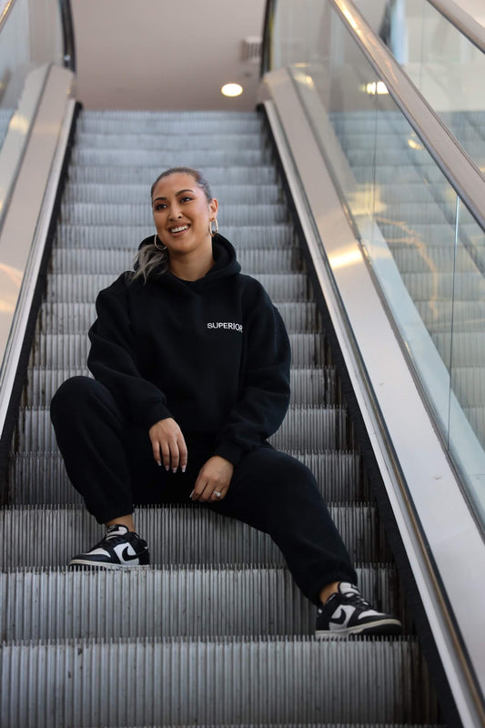 smiling sitting down on escalator