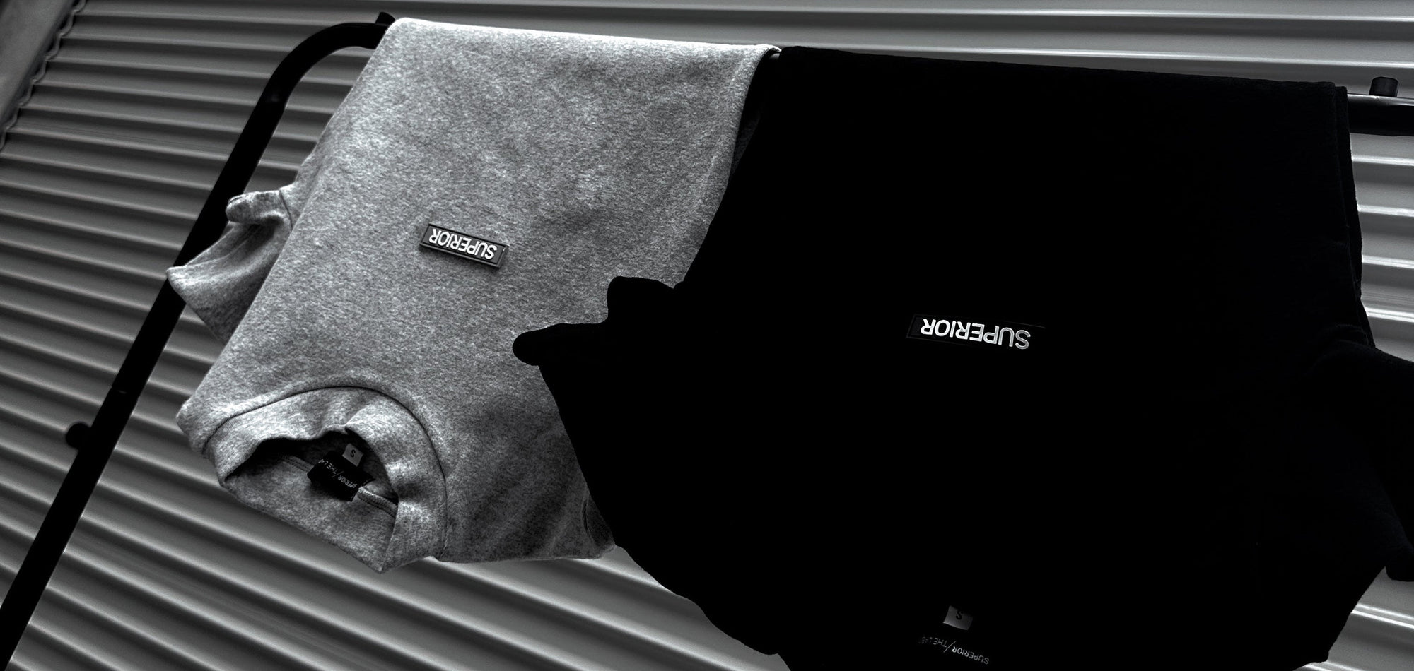 2 superior bodysuits hanging on rack